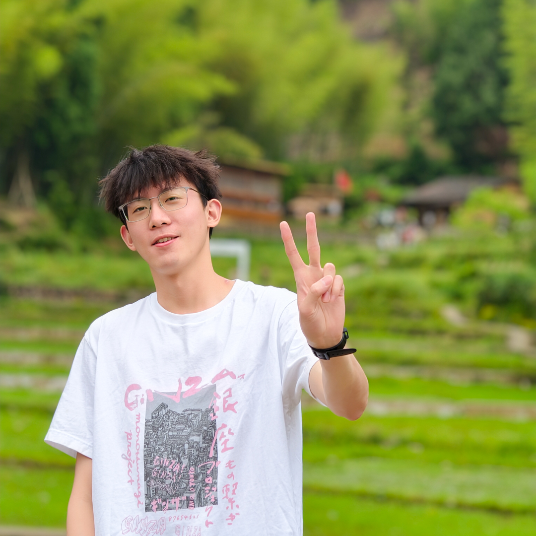 Situo Zhang outdoors in a green landscape